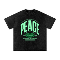 T-shirt oversized PEACE en noir délavé - lettrage varsity vert menthe sur coton snow wash