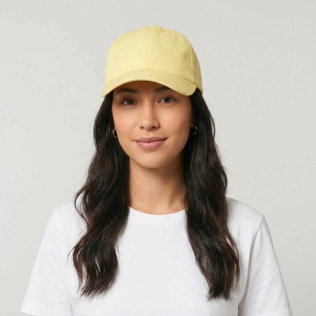 Casquette femme jaune pastel portée de face sur fond studio neutre