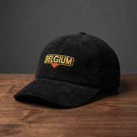 Casquette belge en velours côtelé noire Belgium - badge BELGIUM vue de face sur fond bois et charbon