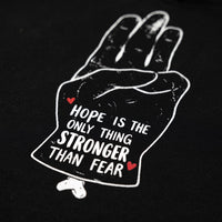 Macro de l'impression Hope is the only thing stronger than fear sur le molleton du hoodie oversize original noir