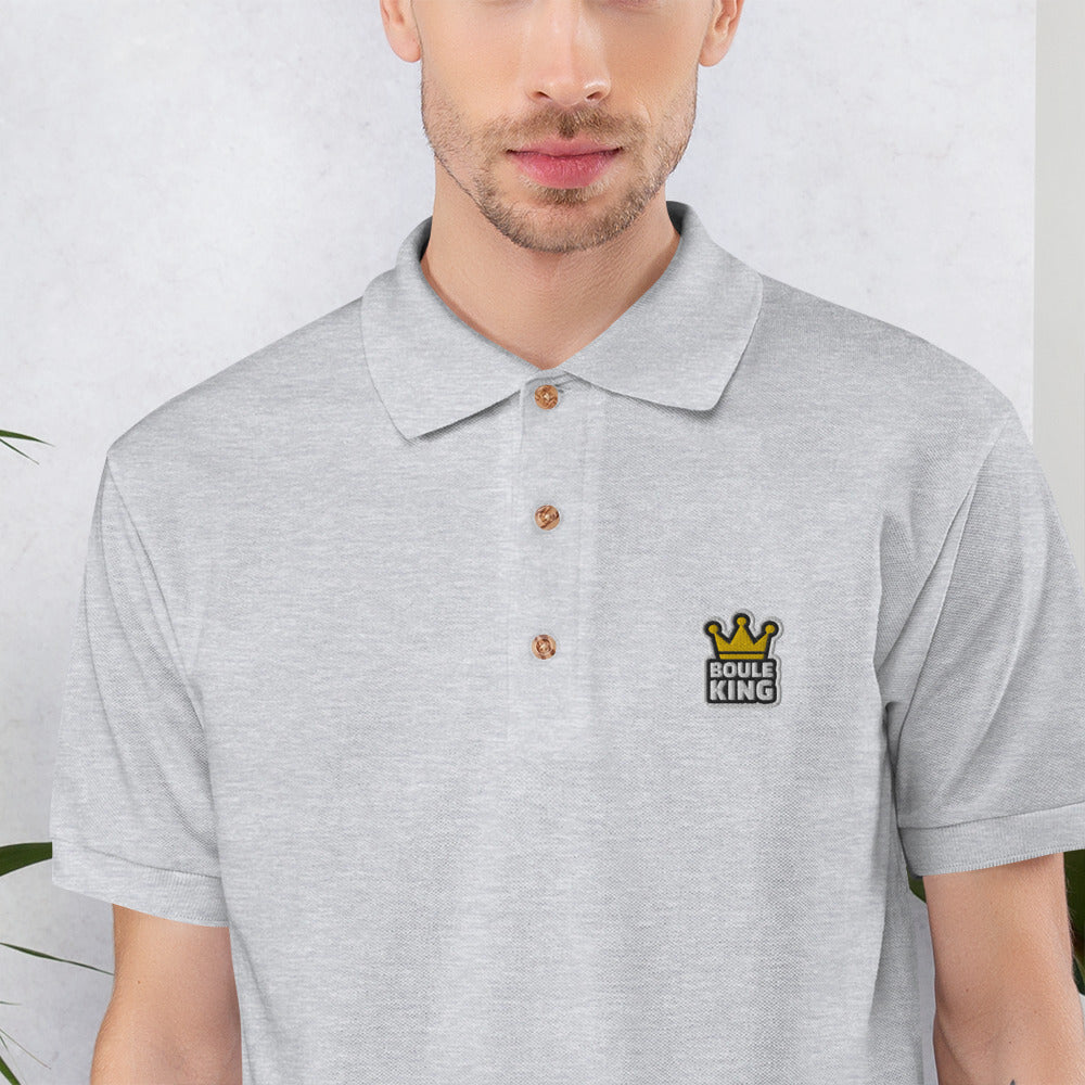 Gros plan de la broderie Boule King sur le polo de pétanque gris sport