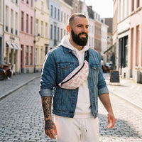 Sac banane imprimé vache rose pâle porté par un homme, look streetwear en Belgique | CHT'M Boutique