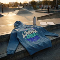 sweat à capuche Gen Z « L'avenir c'est nous » bleu acier posé sur les marches d'un skatepark au coucher du soleil – CHT'M Boutique