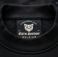 Étiquette intérieure CHT'M Boutique cousue dans le col du sweat