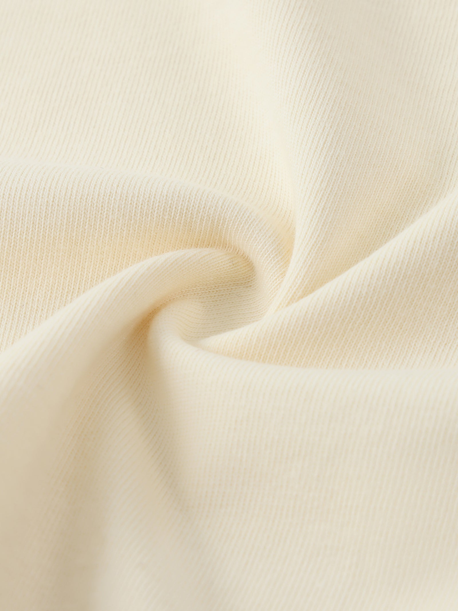 Texture du coton du crop top femme abricot clair - gros plan sur la maille souple et fine