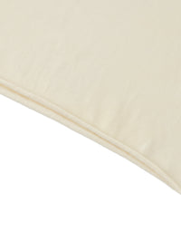 Ourlet roulé du crop top femme abricot clair - bas laissé brut qui roulotte naturellement