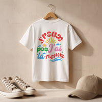 T-shirt enfant oversized blanc J'peux pas j'ai la flemme sur cintre, baskets et casquette posees au sol devant un mur de platre