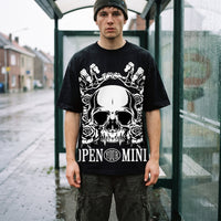 Homme en bonnet et t-shirt oversized noir CHT'M, immense crâne Open Your Mind, abribus sous la pluie