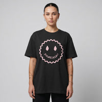 T-shirt Dour Festival DOUREUUUH oversize noir porté par une femme, smiley acid holographique, studio