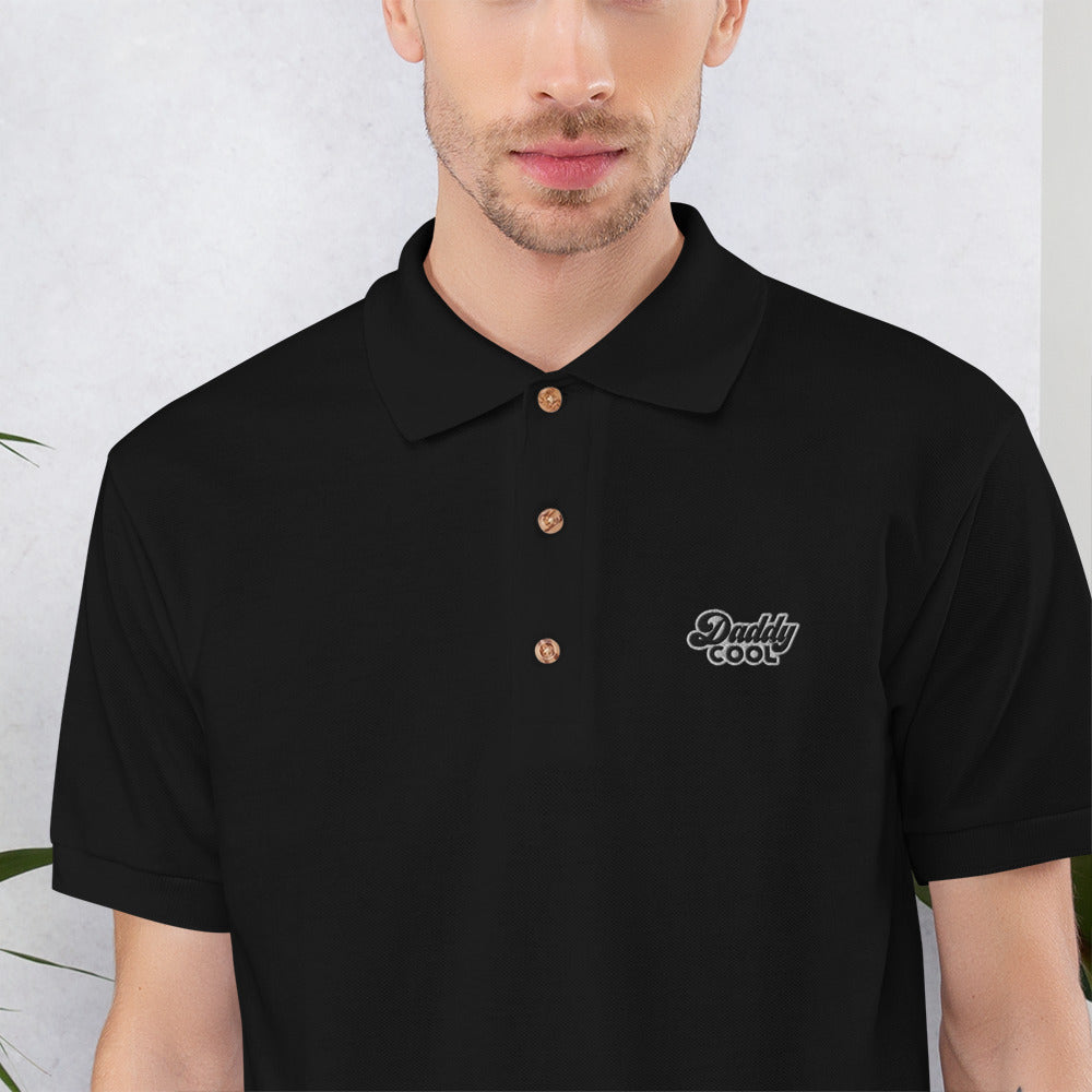 Gros plan de la broderie Daddy Cool sur le polo noir