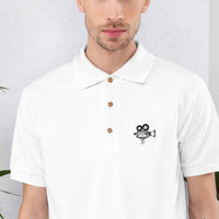 Gros plan de la broderie caméra vintage sur le polo blanc